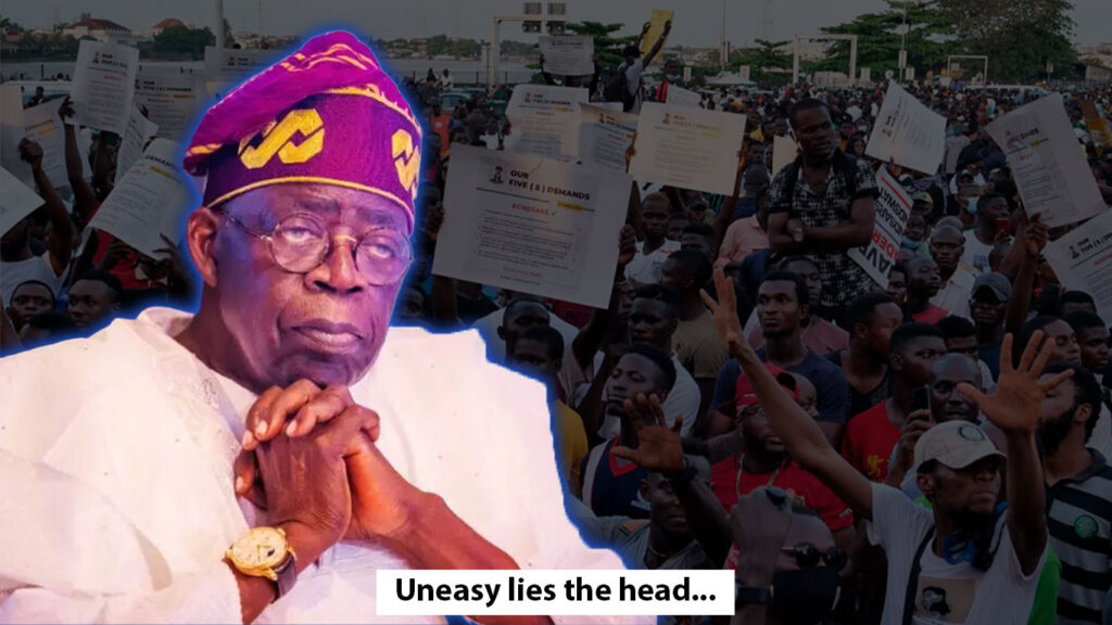 president tinubu in front of a crowd of protesters